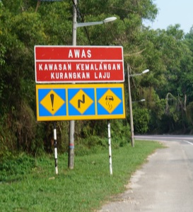 An incredibly confusing sign we saw daily in Malaysia. Still not totally sure what it's warning us about..